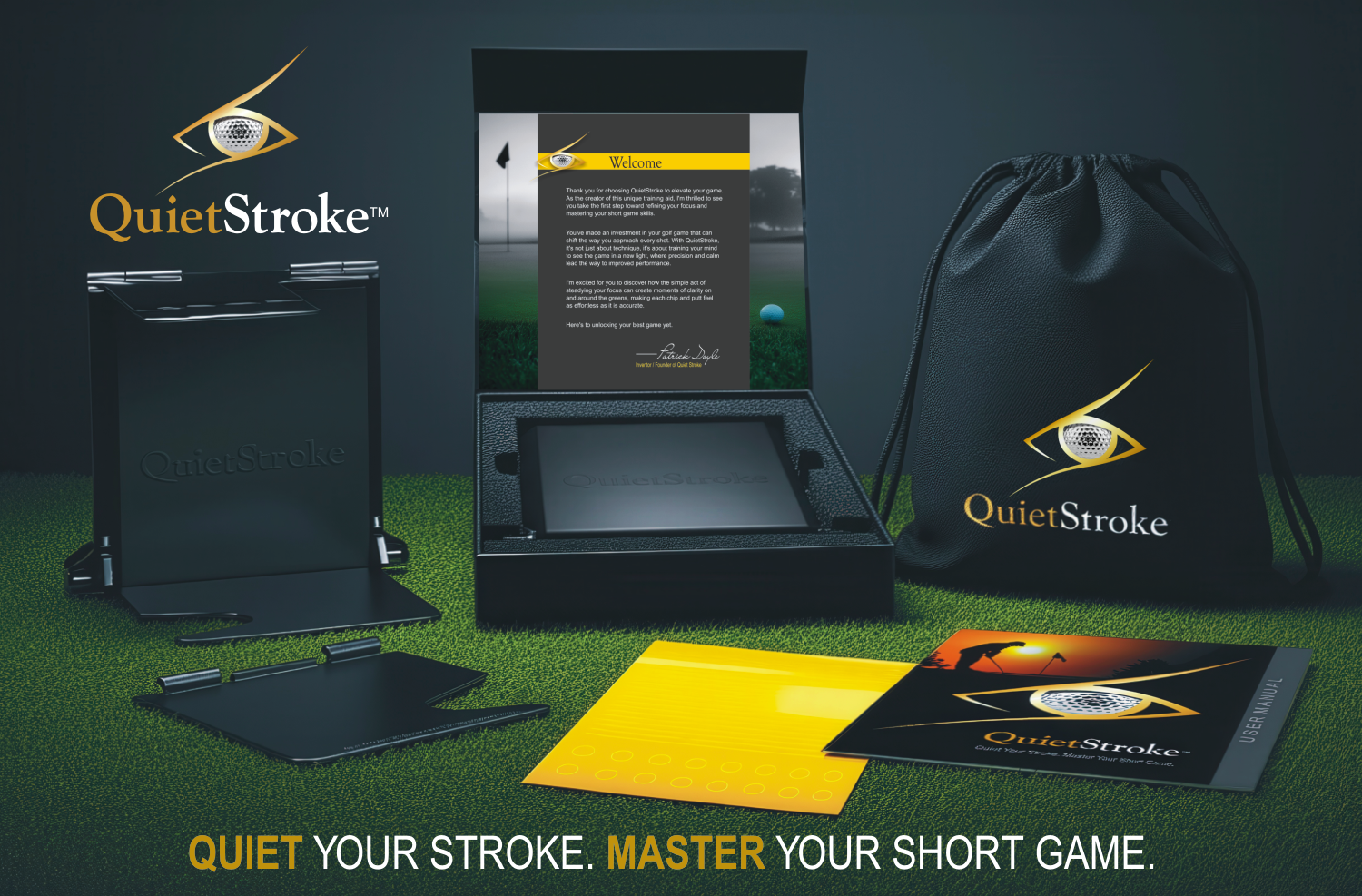 QuietStroke golf training kit displayed on green turf, showing the premium black presentation box open with foam insert, training device inside, branded drawstring storage pouch, user manual, alignment stickers, and modular platform components arranged neatly.